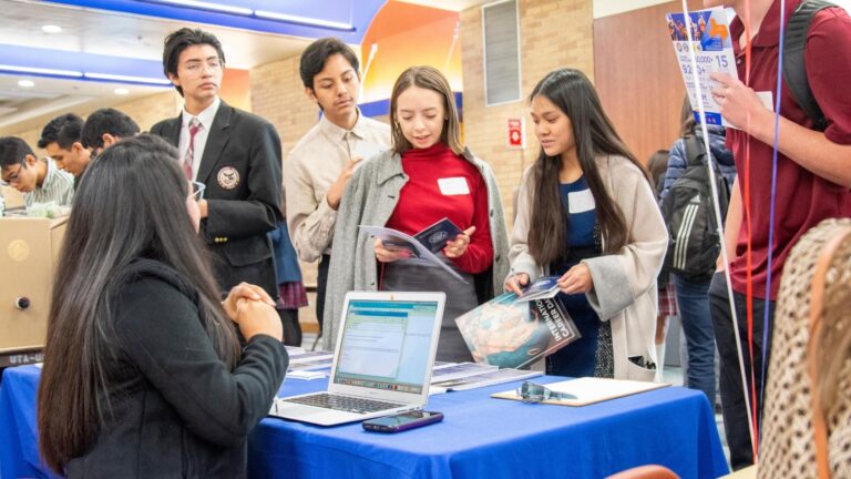 Members gather at an event table.