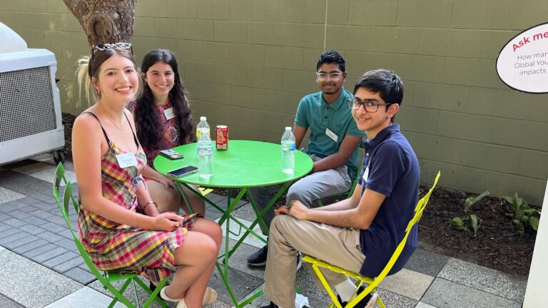 Four of our 20 Under 20 gather at an outdoor table.