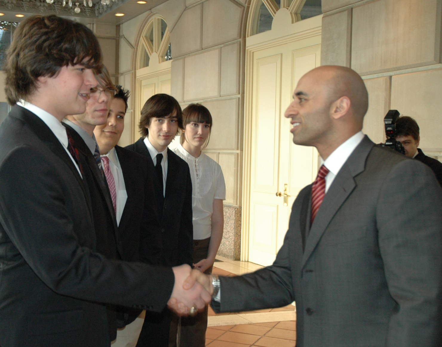 Yousef Al Otaiba is the United Arab Emirates ambassador to the United States shaking hands with students